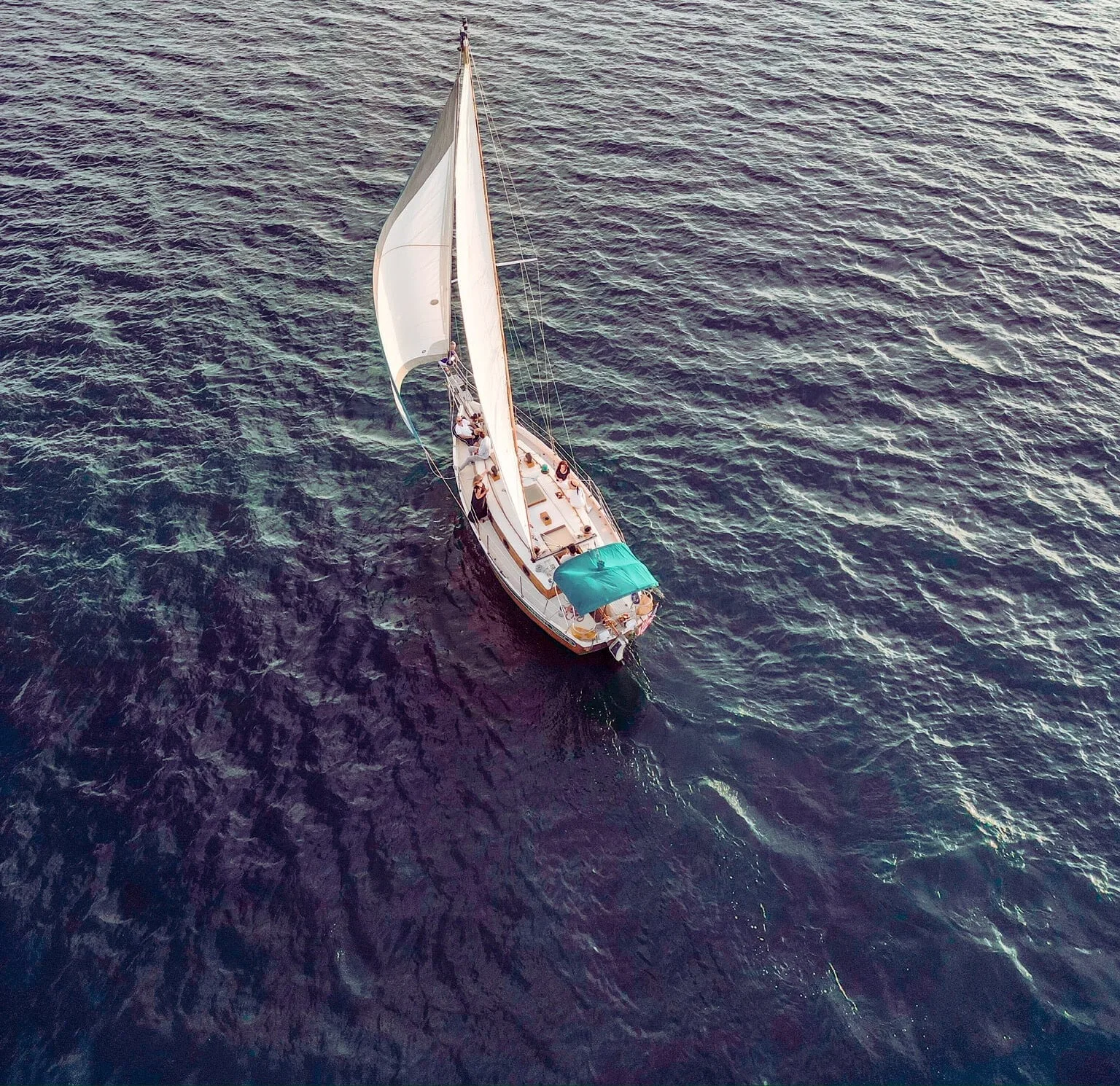 Aerial top-down view of the Lord Nelson sailboat on the deep blue waters of Lake Lanier