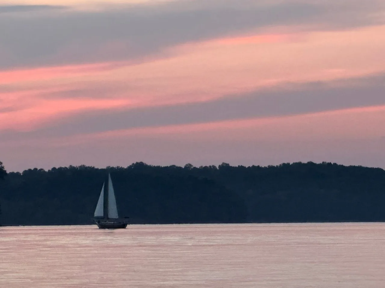 The Lord Nelson at a distance under a pink and lavender sky on Lake Lanier
