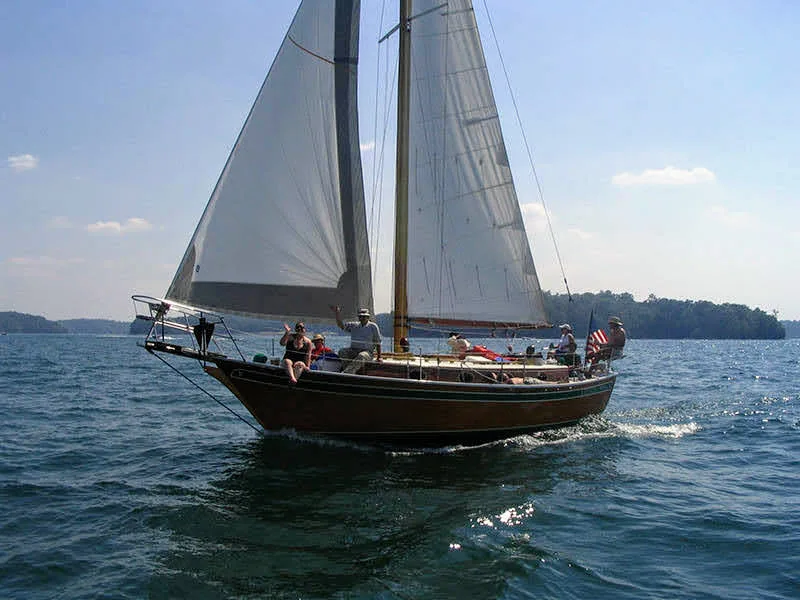 Classic sailboat Lord Nelson under full sail with American flag on Lake Lanier