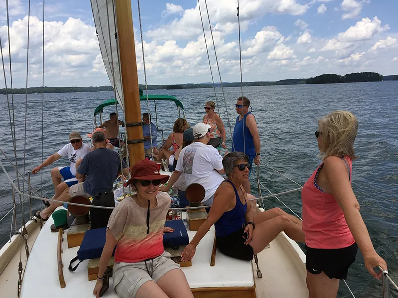 Group of fourteen guests enjoying a corporate team building cruise on Lake Lanier