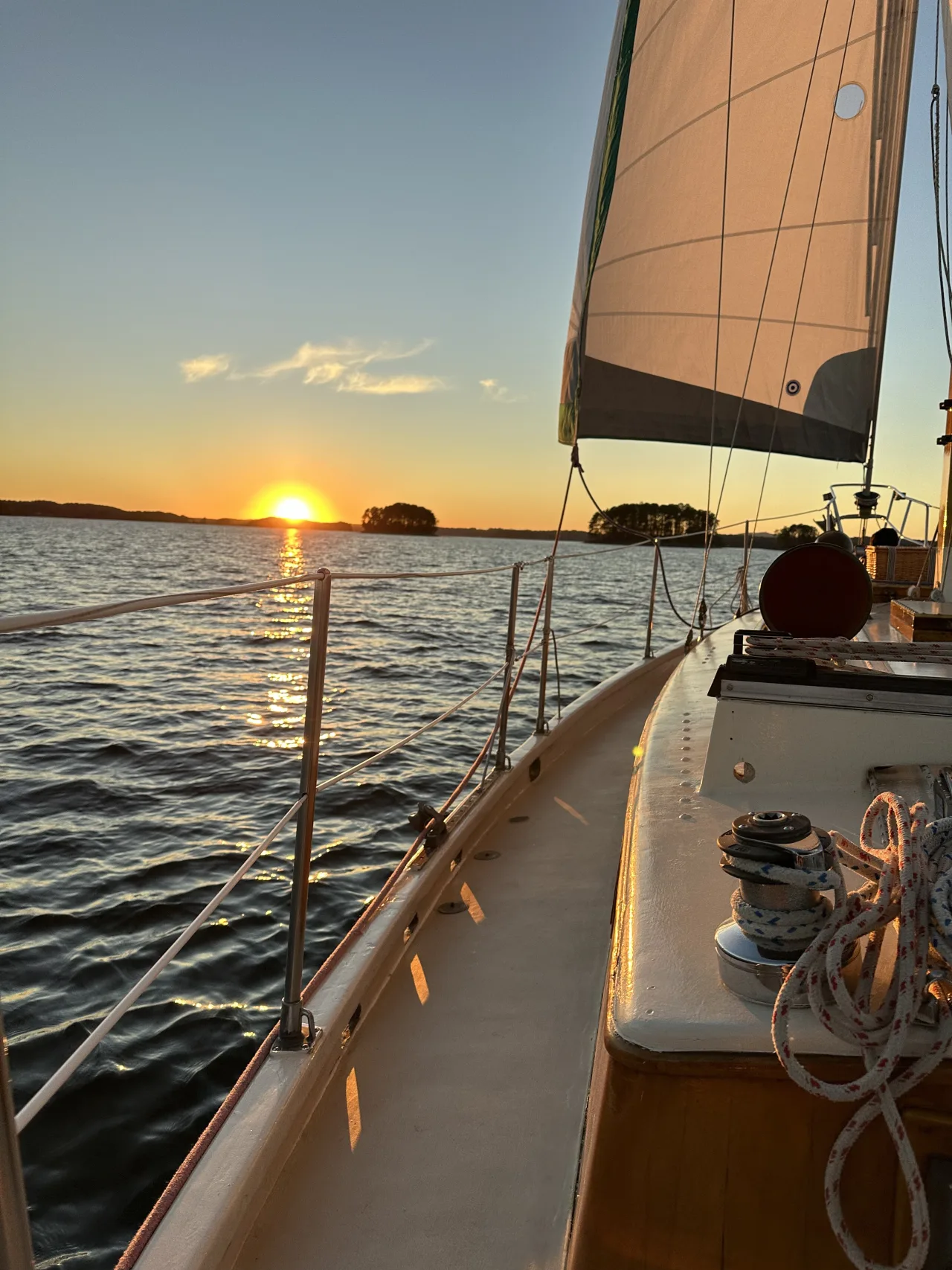 On-deck view of brass winch and rope at sunset aboard Lord Nelson