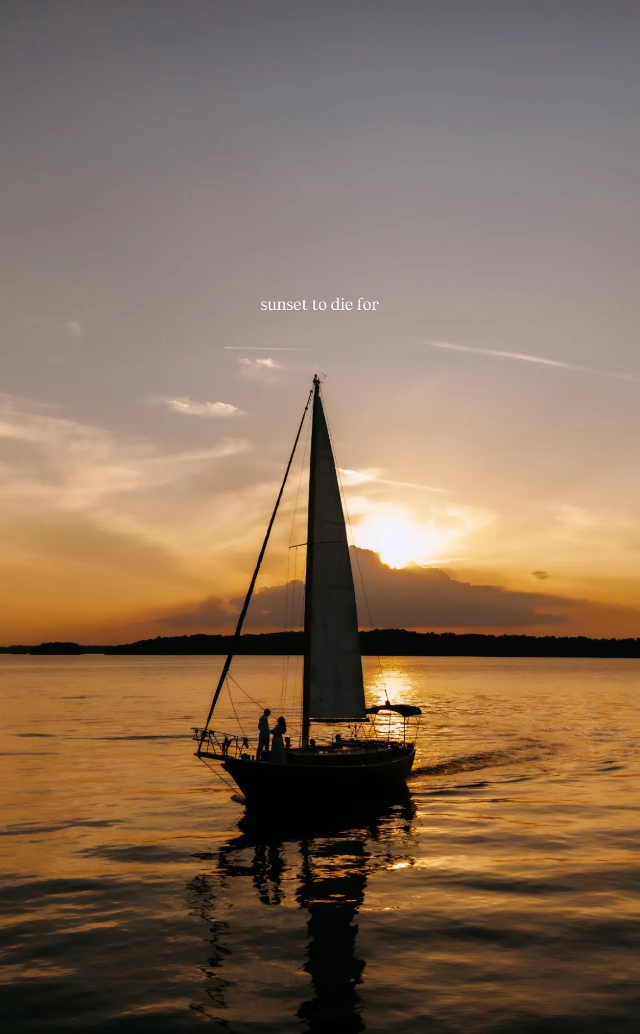 Lord Nelson silhouetted against a fiery orange sun at dusk on Lake Lanier