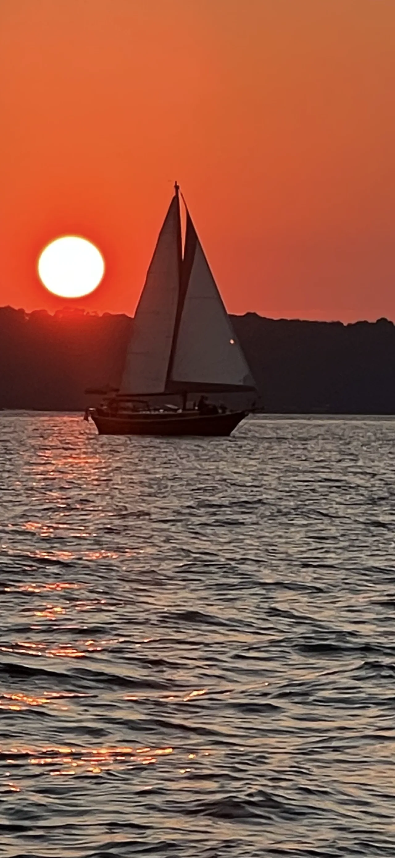 Couple silhouetted on the deck of Lord Nelson at sunset on Lake Lanier